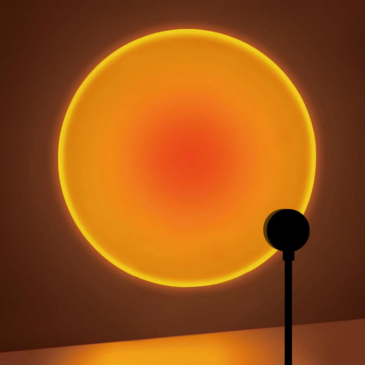 Sunset projection lamp casting a glowing orange circle on a wall